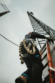 Telecom Worker Climbing Antenna Tower photo