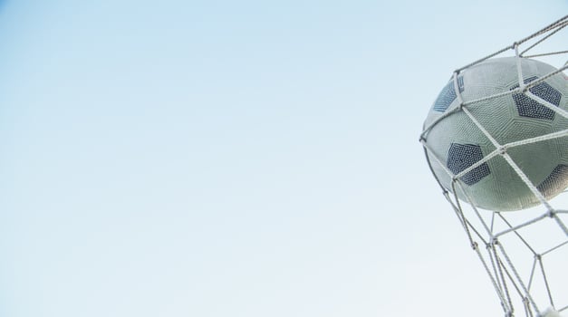 Soccer ball in the net of a goal. photo