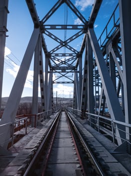 Railroad bridge of metal beams. photo