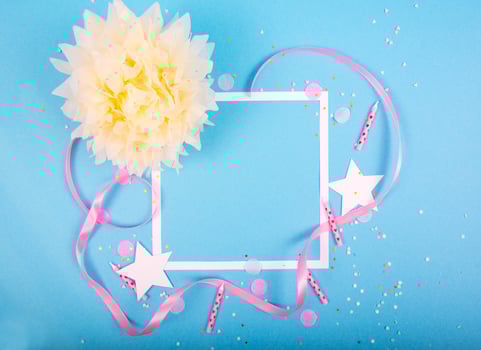 Party Holiday Background with ribbon, stars, birthday candles, gift box empty frame and confetti on blue background photo
