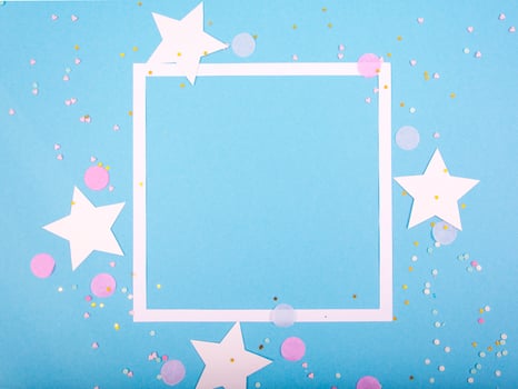 Party Holiday Background with ribbon, stars, birthday candles, gift box empty frame and confetti on blue background photo