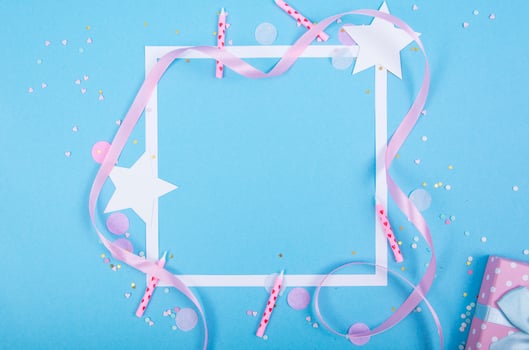 Party Holiday Background with ribbon, stars, birthday candles, gift box empty frame and confetti on blue background photo
