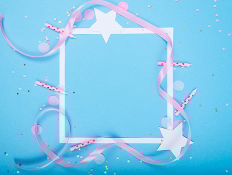 Party Holiday Background with ribbon, stars, birthday candles, gift box empty frame and confetti on blue background photo