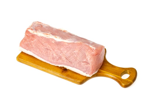 Fresh pink piece of raw pork meat, chop on white background. Studio Photo