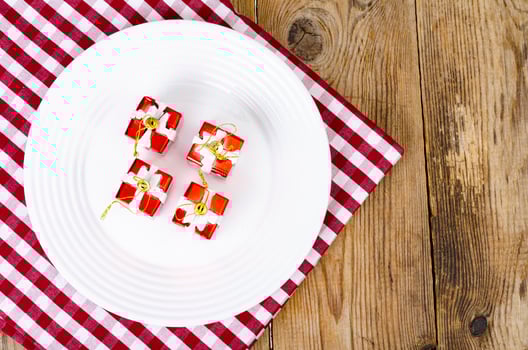 Christmas and New Years concept. White plate, red tablecloth. Studio Photo