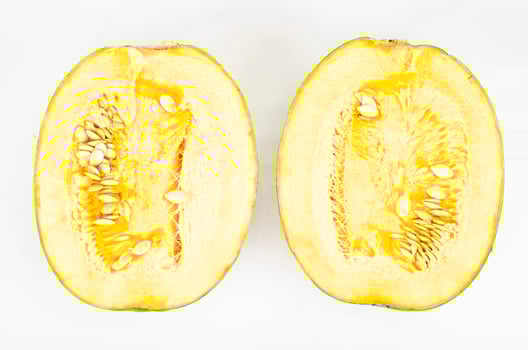 Small round pumpkin cut in half on white background. Studio Photo. photo
