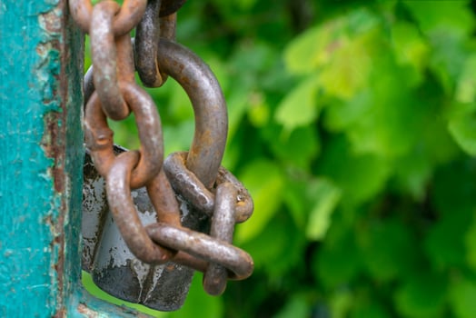 Old gray padlock on a chain. Vintage lock close up. photo