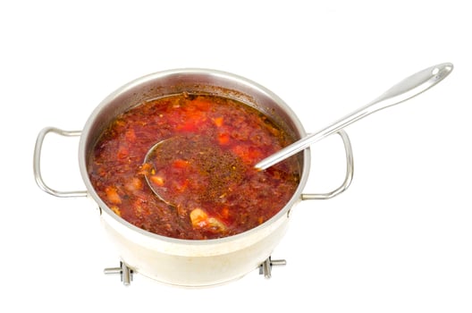 Saucepan with vegetable beetroot soup on white background. photo