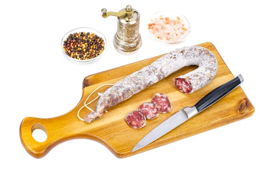 Dry-cured sausage in white mold casing. Photo
