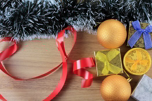 wooden background, christmas decoration with balls and gifts, decorative tree branches photo