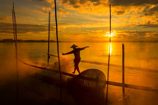 The work of fishermen on the Mekong River raft during the sunrise is a hustling and indigenous way of life in Nong Khai province, opposite to Vientiane Laos. photo