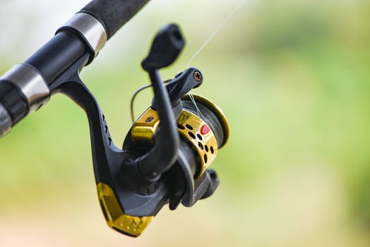 Fishing reel on Fishing rod, Fishing on the feeder with nature background photo