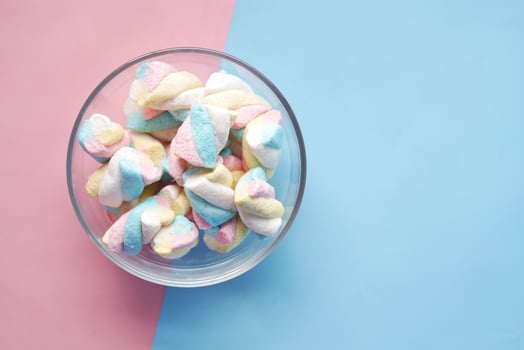 marshmallow candy in a bowl on blue photo