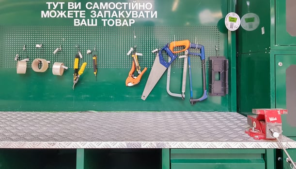 Ukraine, Kiev - May 09, 2020. Work tools on the board and in the workshop. Workshop scene. A lot of old tools on a dirty desktop. The concept of carpentry and painting. photo