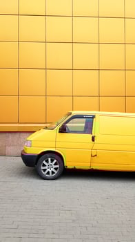 Ukraine, Kiev - March 27, 2020. Yellow Transporter in yellow on a background of a yellow building. photo