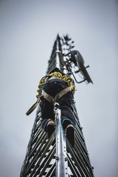 Telecom Worker Climbing Antenna Tower photo