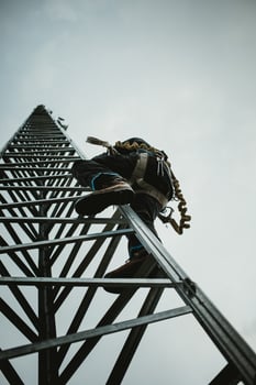 Telecom Worker Climbing Antenna Tower photo