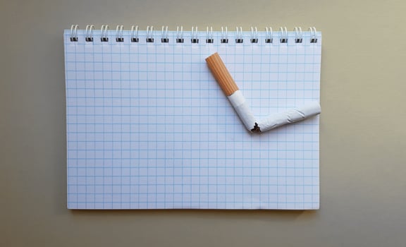 World No Tobacco Day, No Smoking Day. Broken cigarette on a business notebook, place for your text photo