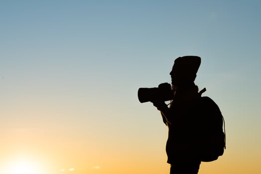 Silhouette of tourist woman standing in the mountain photo