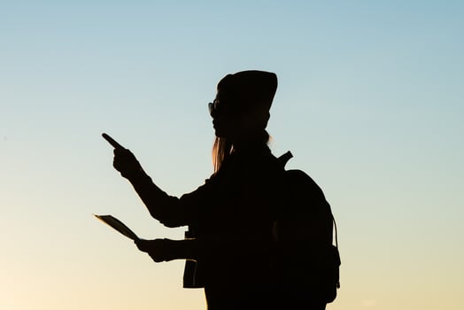 Silhouette of tourist woman standing in the mountain photo