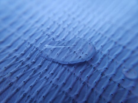 Water droplets fall over textile surface photo
