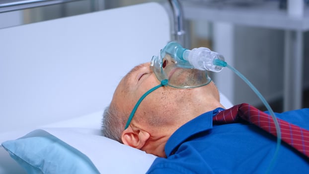 Sick old man in respiratory mask photo