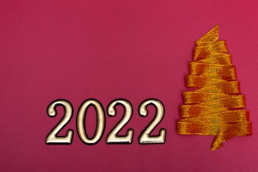 Christmas concept. Gold Christmas tree made of ribbons and gold numbers on a pink background. Template for postcards, packaging. photo