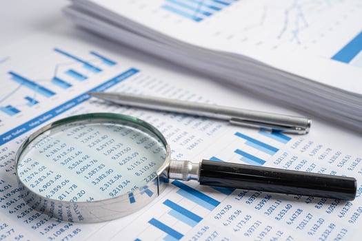 Magnifying glass on charts graphs paper. Financial development, Banking Account, Statistics, Investment Analytic research data economy, Stock exchange trading, Business office company meeting concept. photo