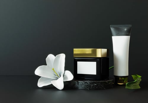 Cream jar and squeeze tube on pastel black background. photo