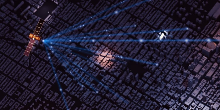 Transmitting signals through communications satellites in the sky and the capital city with tall buildings photo