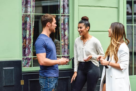 Multiracial group of friends having fun in urban background photo