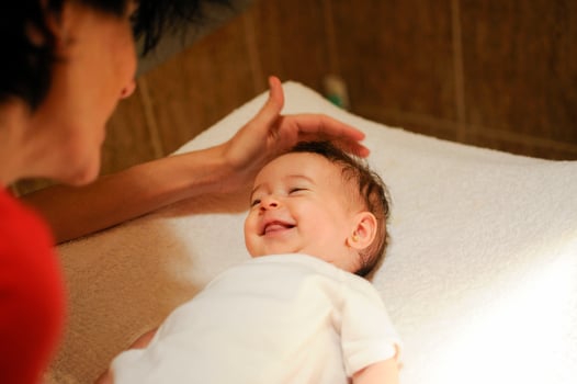 Baby girl two months old smiling to her mother photo