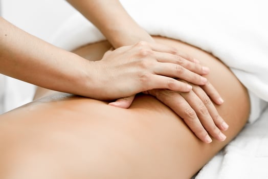 Young woman receiving a back massage in a spa center. photo