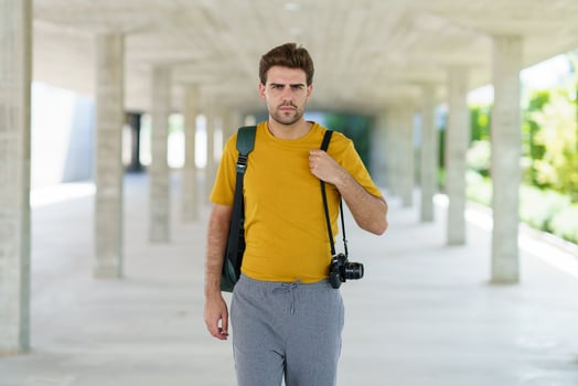 Millennial man taking photographs with a SLR camera photo