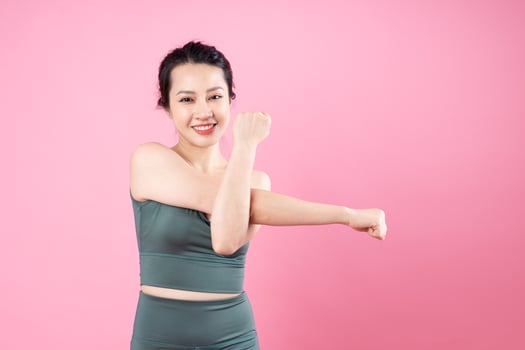 Asian fitness girl portrait, isolated on pink background photo