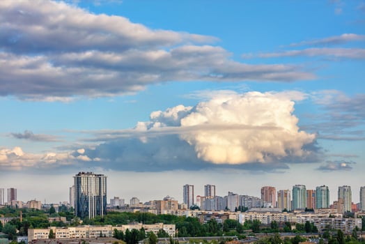 A large curly figured cloud hung over the city. photo