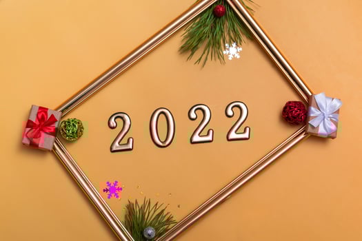 New Year's layout on a beige background Christmas balls, branches of a Christmas tree, a gift box and a gold frame, a mockup of a postcard, an invitation photo