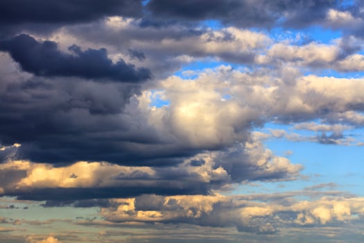 Storm clouds gather in the sky in the rays of the setting sun. photo