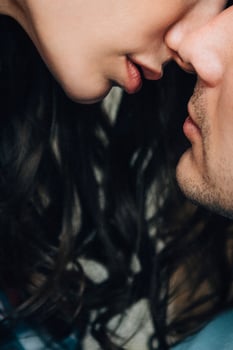 a guy and a girl sit on the bed in the room photo