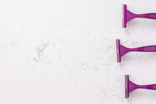 Purple shaving machine on a white background. The concept of hygiene. Place for the label. photo