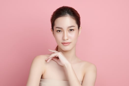 Beautiful young asian woman with clean fresh skin on pink background, Face care, Facial treatment, Cosmetology, beauty and spa, Asian women portrait. photo