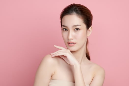 Beautiful young asian woman with clean fresh skin on pink background, Face care, Facial treatment, Cosmetology, beauty and spa, Asian women portrait. photo