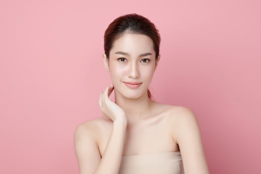 Beautiful young asian woman with clean fresh skin on pink background, Face care, Facial treatment, Cosmetology, beauty and spa, Asian women portrait. photo