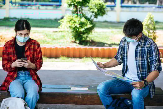 Male and female tourists look at the map beside the railway. photo