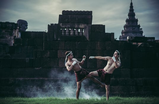 Two boxers fight with the martial arts of Muay Thai. photo