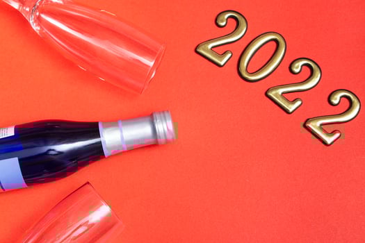 Top view flat new year mockup on red background with numbers, champagne and glasses. Close-up. New Year 2022, with copy space photo