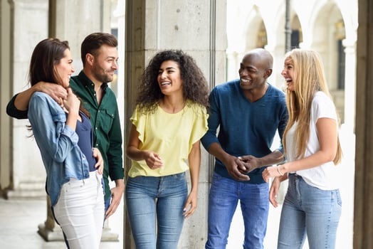 Multi-ethnic group of friends having fun together in urban background photo