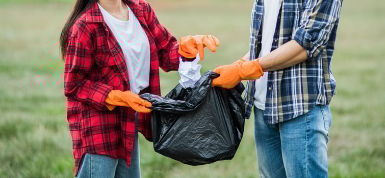 Men and women help each other to collect garbage. photo