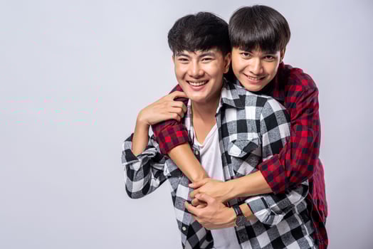 Two men who love each other hug from behind another. photo