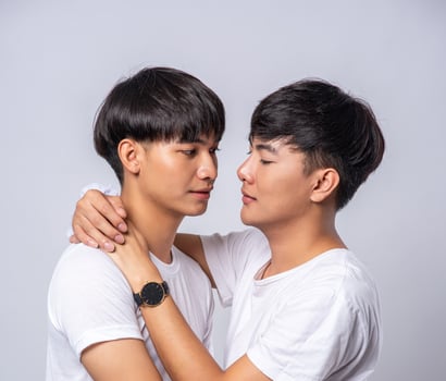 Two men who love each other happily hug each other. photo